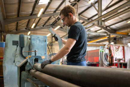 Employé dans une usine travaillant sur une machine d'usinage de métaux